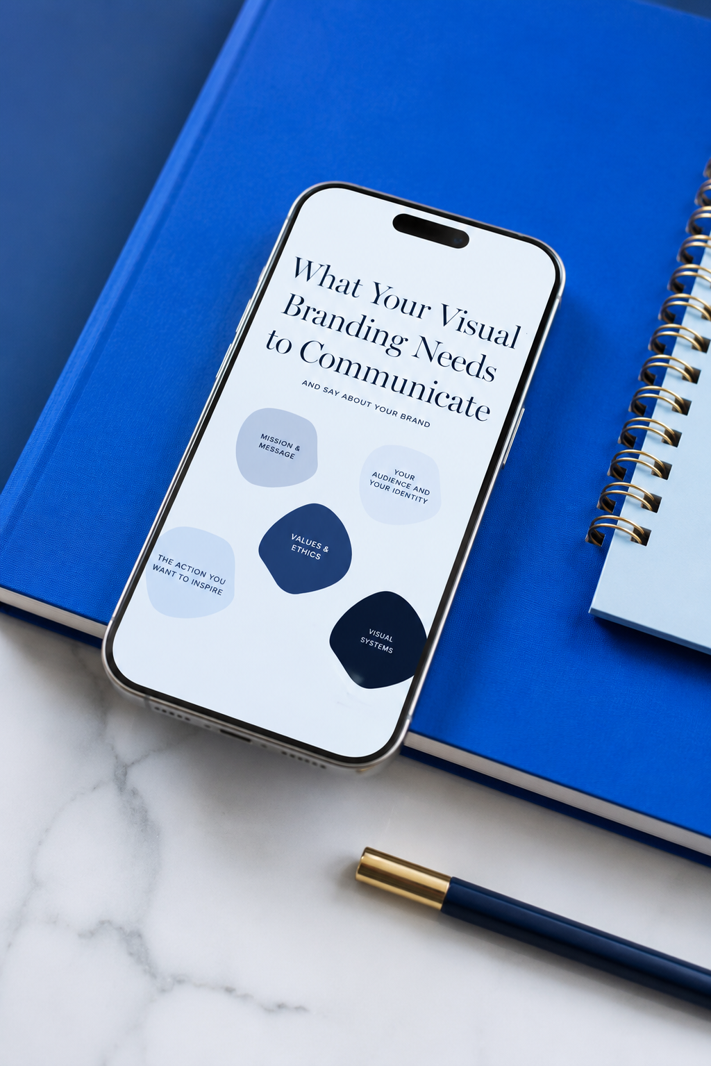 Visual branding notebook and phone flatlay